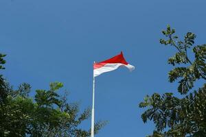 17 August 1945, Indonesian flag against sky background. Independence day concept photo