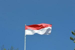 17 August 1945, Indonesian flag against sky background. Independence day concept photo