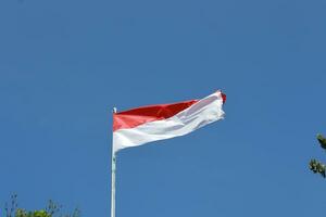 17 August 1945, Indonesian flag against sky background. Independence day concept photo