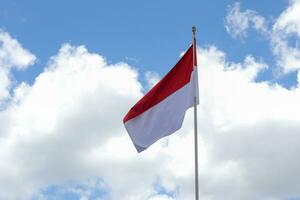 17 August 1945, Indonesian flag against sky background. Independence day concept photo