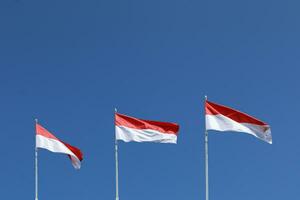 17 August 1945, Indonesian flags against sky background. Independence day concept photo