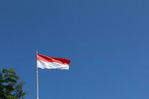 17 August 1945, Indonesian flag against sky background. Independence day concept photo