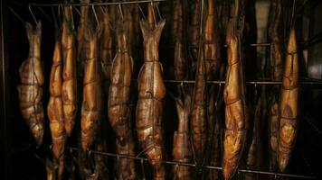 Smoked fish hanging in a smoking cabinet at a fish factory video