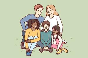 Happy family couple with multiracial children sitting together on lawn in park and smiling looking at camera. Man and woman with adopted children rejoice in presence of large family vector