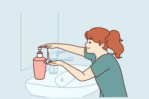 Little girl uses liquid soap to wash hands standing near sink and mirror in bathroom. Child follows hygiene rules with smile and washes hands with soap after coming home from school. vector