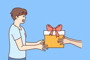 Joyful boy receives gift box with red ribbon on eve of birthday or christmas holidays. Hands with big gift box near teenager schoolboy, for concept of present or award for academic achievement vector