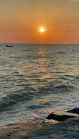 Vertical,  The sunset reflects on the glistening sea, golden hour. Bangsaen Chonburi video