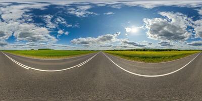 spherical 360 hdri panorama on asphalt road with dividing line among farming field in equirectangular seamless projection, use as sky dome replacement, game development as skybox, VR content photo