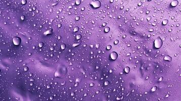 , Lavender color. Texture of light violet purple gel with drops and waves on soft background. Liquid beauty product closeup photo