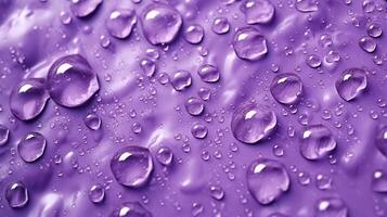 , Lavender color. Texture of light violet purple gel with drops and waves on soft background. Liquid beauty product closeup photo