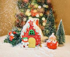 concept of Christmas holiday. Christmas house and snowing background photo