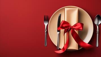 Plate with red napkin and cutlery, minimal Christmas table setting. photo