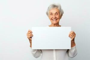 Happy old woman holding blank white banner sign, isolated studio portrait. AI Generated photo