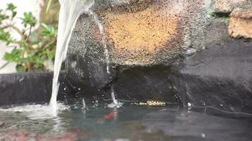 artificial waterfall for fish pond at home. video