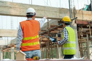 Engineers team use laptop and check the blueprint on site. Contractor and inspector inspection construction during project.civil Forman check quality assurance. Audit, inspect, quality control. photo