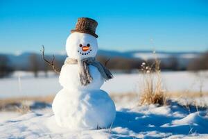 Snowman in winter field under a clear blue sky background photo