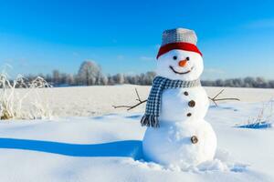 Snowman in snowy field under a clear blue sky background photo