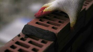 A bricklayer lays a red brick wall video