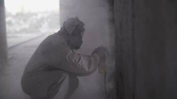 The builder polishes the concrete. Dust from construction work. video