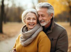 Happy senior couple in autumn park photo