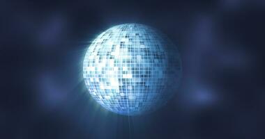Abstract blue mirrored spinning round disco ball for discos and dances in nightclubs 80s, 90s luminous background photo