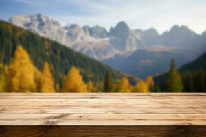 Wooden table top on blurred background of autumn color landscape in dolomites - for display your products photo