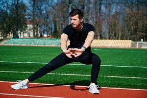 Sport man preparing for jogging outdoors photo