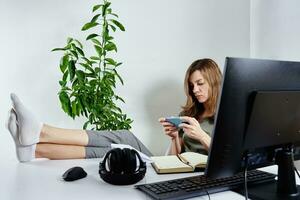 Woman use smartphone while working online photo