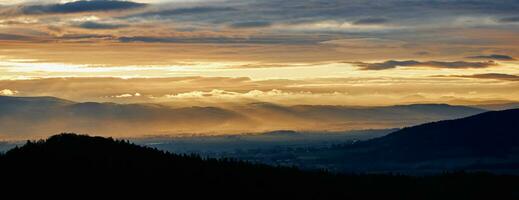 Sunset dramatic sky over mountains shape photo