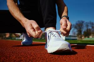 Runner get ready for run, tying sneakers shoelaces photo