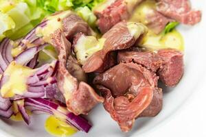 chicken stomach salad green lettuce, onion, salad dressing vegetable food healthy meal food snack on the table copy space food background rustic top view photo