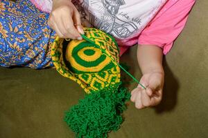 Kochet with green and yellow knitting thread photo