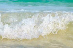 The sea waves hit the sandy beach, the sea is beautiful, crystal clear emerald.Close up photo