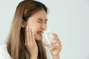 Asian woman feel sensitive teeth after drinking cold, female suffer tooth, decay problems, dental care, tooth extraction, decay problem, bad breath, Gingival Recession, Oral Hygiene instruction photo