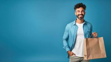 Man with shopping bag blue background photo