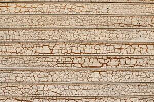 Cracked and abstract grunge texture. Aged material surface backdrop. Weathered effect pattern. Old and dirty background. photo