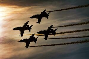 Aerobatic team at airshow. Flight demonstration and formation flying. Air force and military show. Airport and air base. Aviation and aircraft. Fly and flying. photo