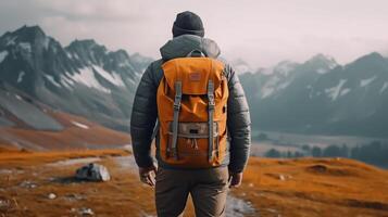 Hiker with a backpack on the background of mountains and lake. photo