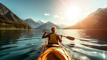 Young woman kayaking on mountain lake. Adventure and sport concept photo