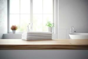 Stack of white towels on wooden table in modern kitchen photo