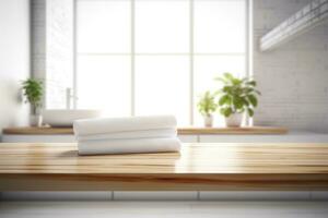 Stack of white towels on wooden table in modern kitchen photo