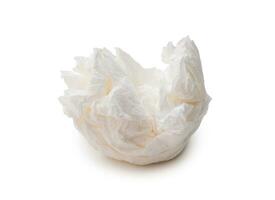 Single screwed or crumpled tissue paper or napkin in strange shape after use in toilet or restroom isolated on white background with clipping path. photo