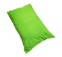 Green pillow at hotel or resort room isolated on white background with clipping path. Concept of comfortable and happy sleep in daily life photo