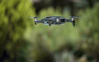 dark grey drone flying over a green background photo