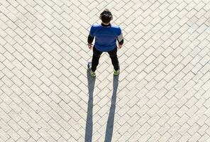 view from above of a young man working out listening to music. concept of healthy living. photo