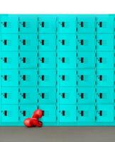 Boxing gloves laying on a concrete floor with a locker in the background. photo