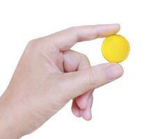 Man's hand holding a gold coin isolated on white background photo