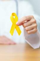 Yellow September, Suicide prevention day, Childhood, Sarcoma, bone and bladder cancer Awareness month, Yellow Ribbon for supporting people life and illness. Healthcare and World cancer day concept photo
