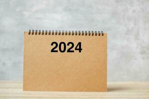 2024 Happy New Year calendar on table. countdown, Resolution, Goals, Plan,  Action and Mission Concept photo