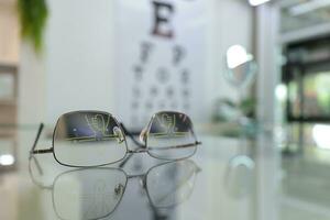 Closeup of eyeglass in optical store, glasses on the glass in clinic photo